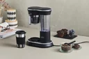 Coffee machine with grinder and stainless steel drinking cup