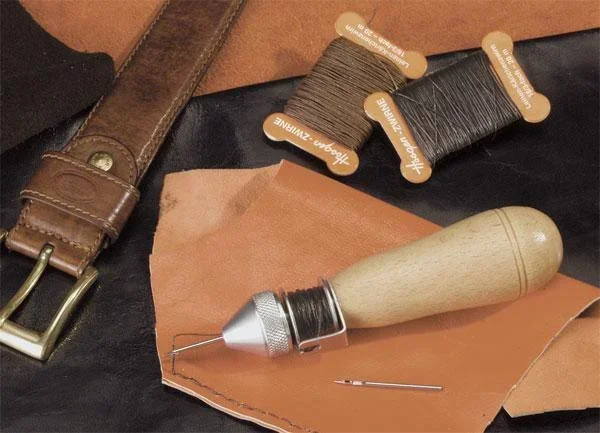 Hand sewing machine with spool